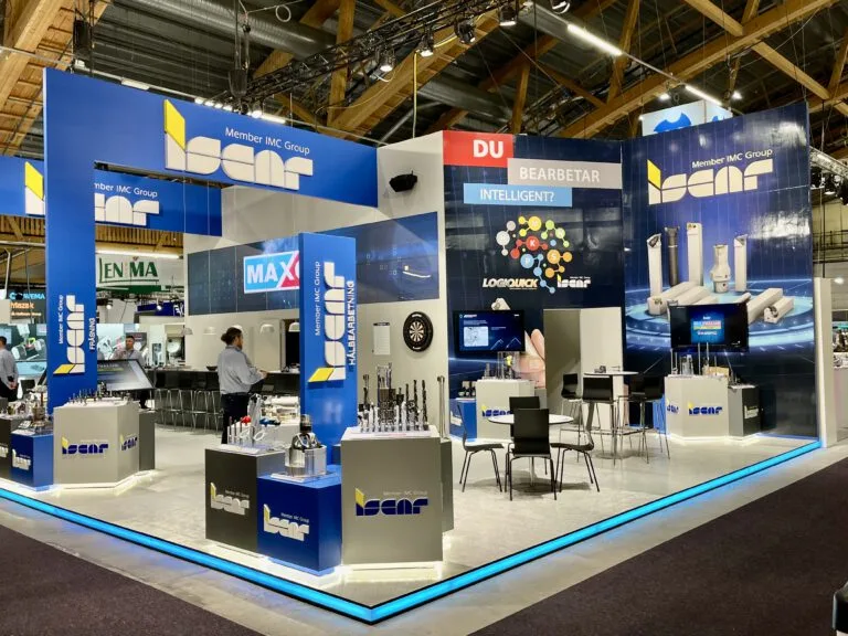 Iscars blå mässmonter med produktväggar, disk och LED-list i golvet, byggd av Wilzéns Expo
